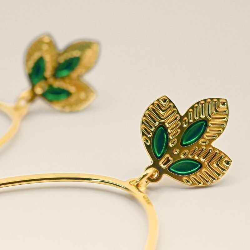 Grandes créoles épurées tout en légèreté. Les 3 feuilles viennent habiller gracieusement votre lobbe et donner une pointe de couleur. Les motifs sur le bas de la boucle donnent à l'ensemble le caractère Indien. Bijou seul, Crédit GEMITY
